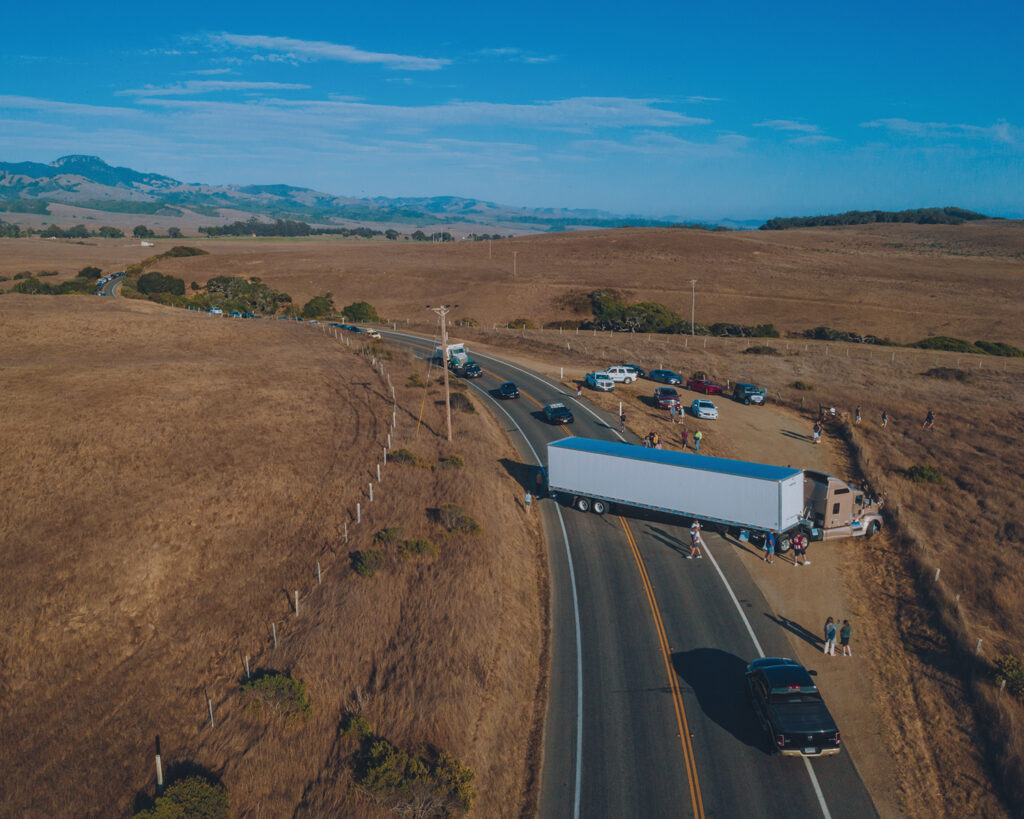 Aerial view of a semi truck on a highway involved in an accident scene